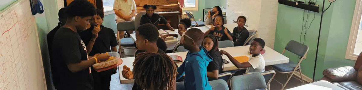 Students and volunteers around the tables during club time