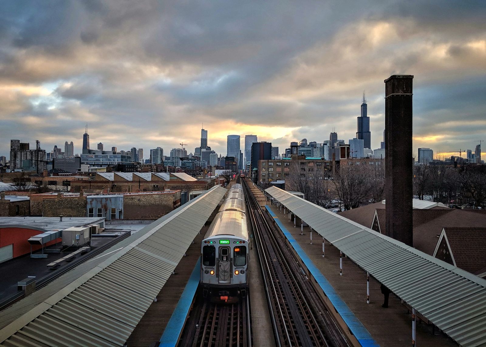 The Chicago skyline at dusk, seen down the elevated train tracks from Englewood